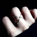 Diamond-encrusted four-pointed star ring